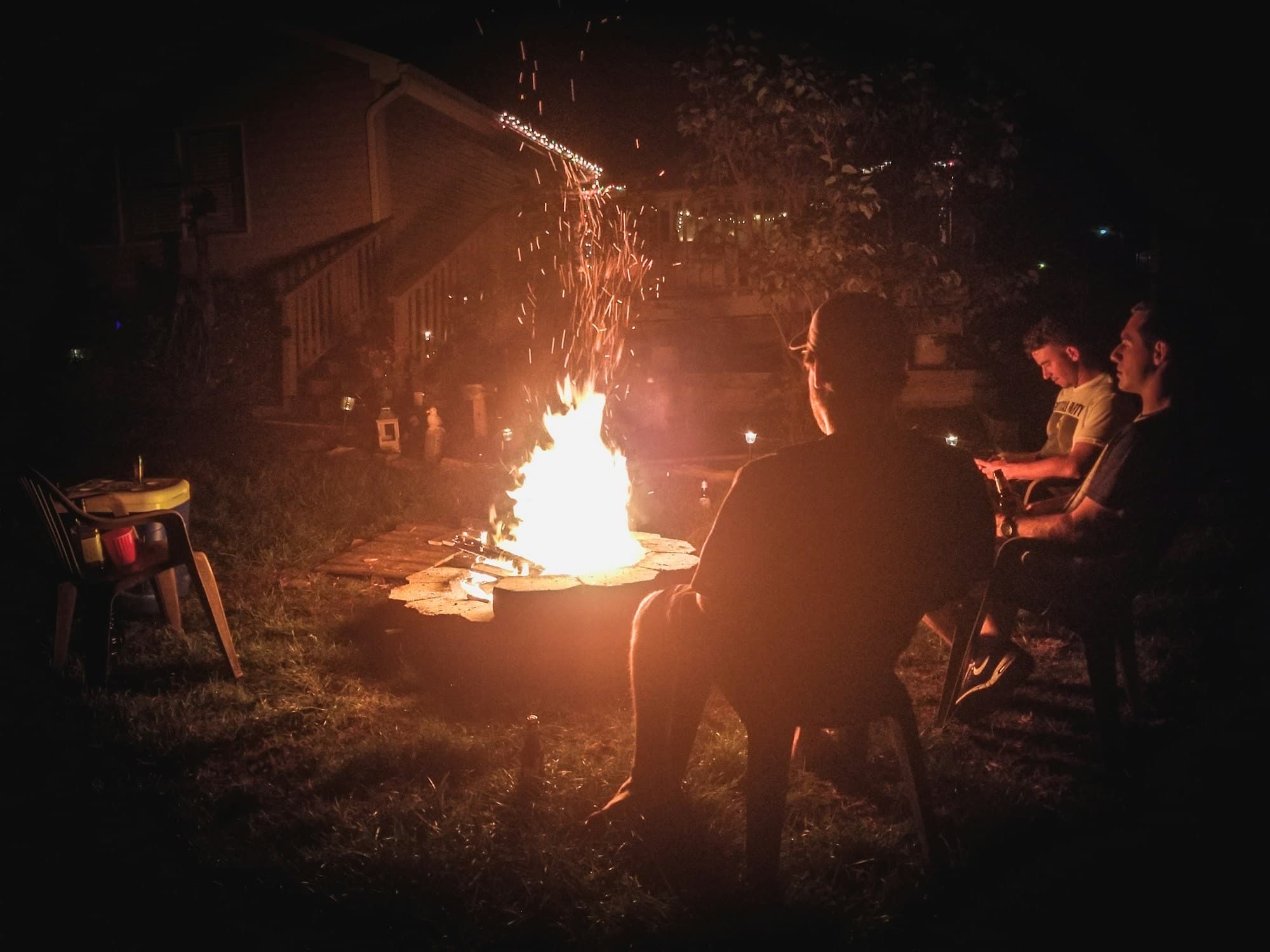 Guests around a bonfire under the stars